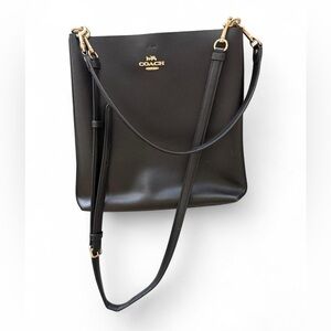 Coach black leather shoulder bag with gold hardware and adjustable straps